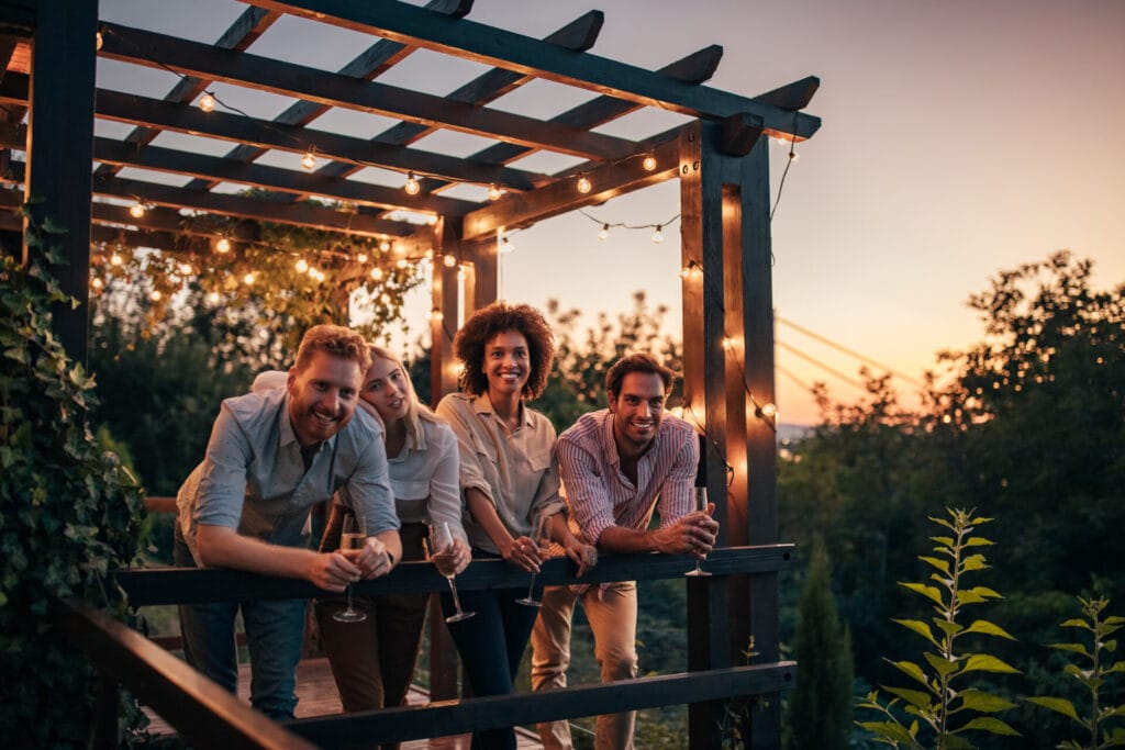 group of friends enjoying a good time under a pergola