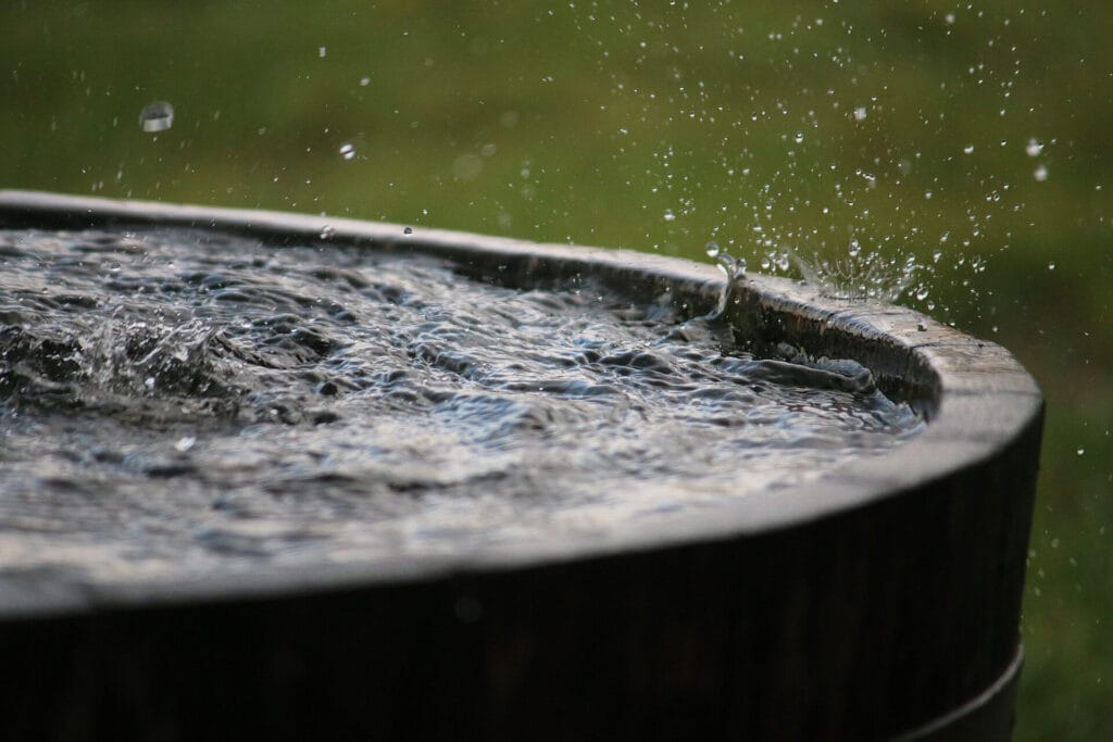 closeup shot of rain falling in a wooden barrel fu 2023 11 27 04 52 31 utc