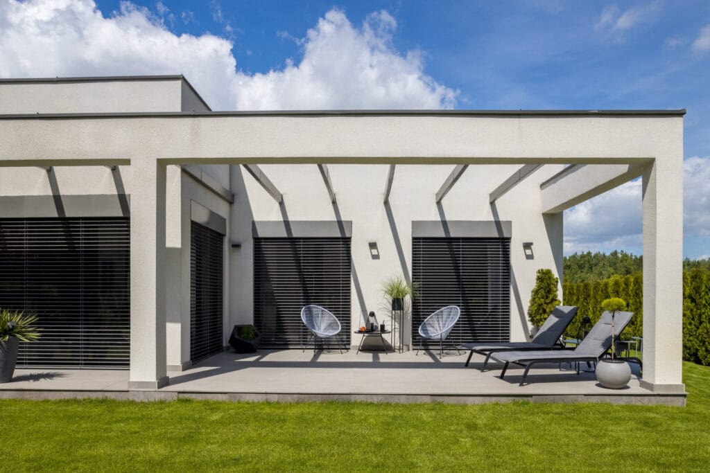 outside view of elegant suburban house with big window green lawn