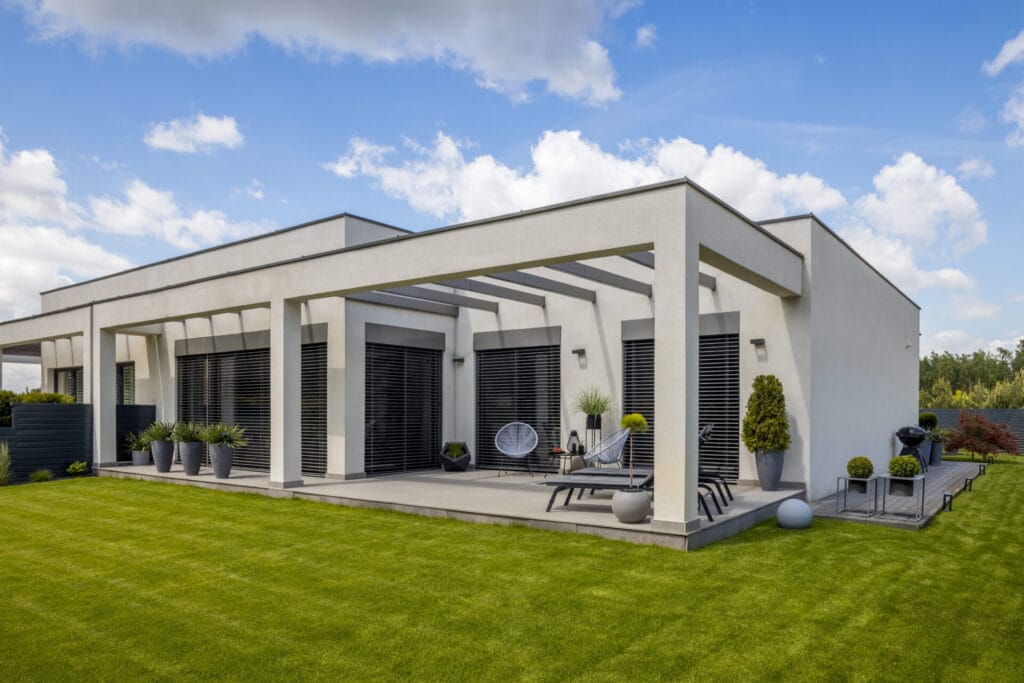 outside view of elegant suburban house with big window green lawn