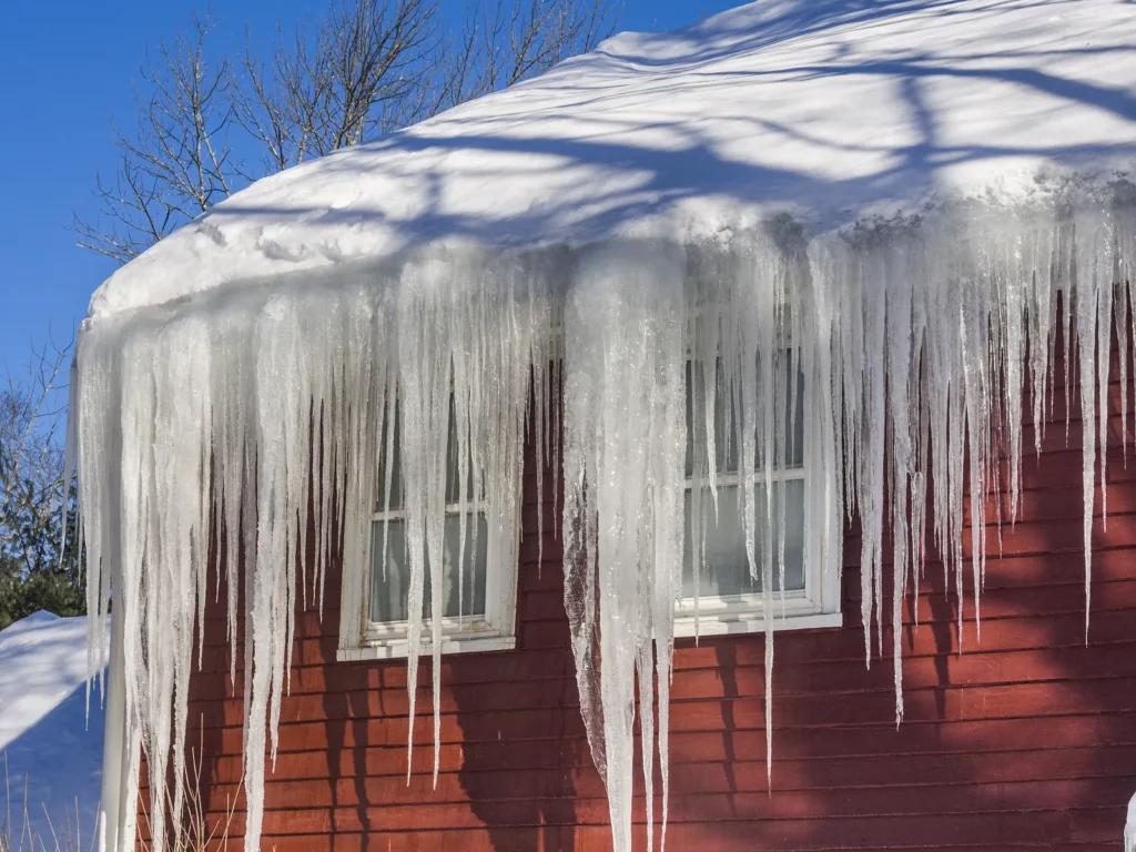 bigstock ice dams and snow on roof and 82911134